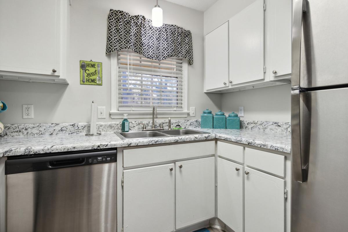 Kitchen with stainless steel appliances in a Quail Run apartment home