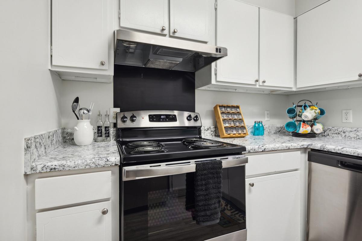 Kitchen with stainless steel appliances in a Quail Run apartment home